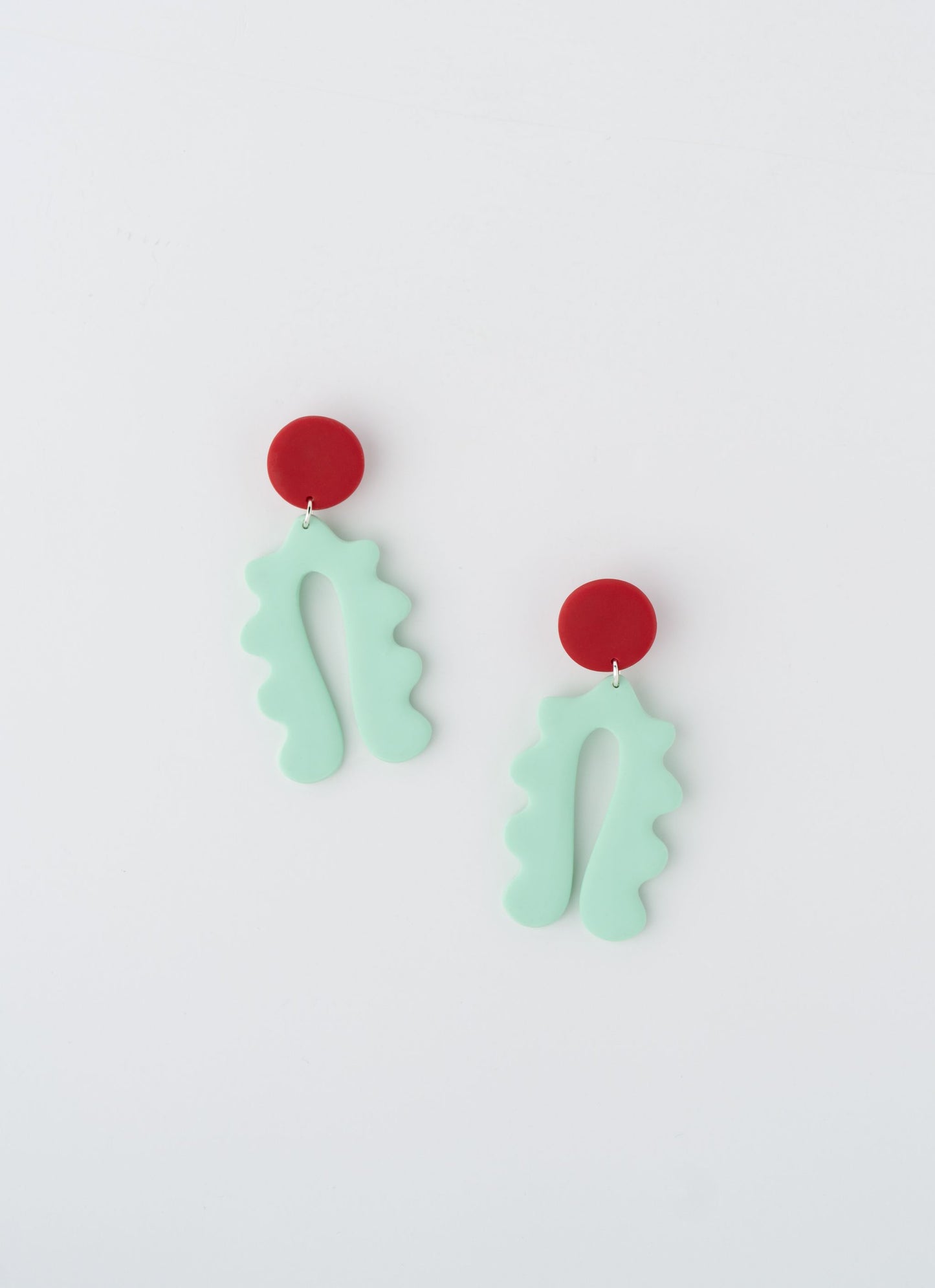 Lucy earrings by APÖ, handcrafted polymer clay earrings with a curved arch design and a small contrasting circle on top, medium-sized, colorful, and lightweight.
