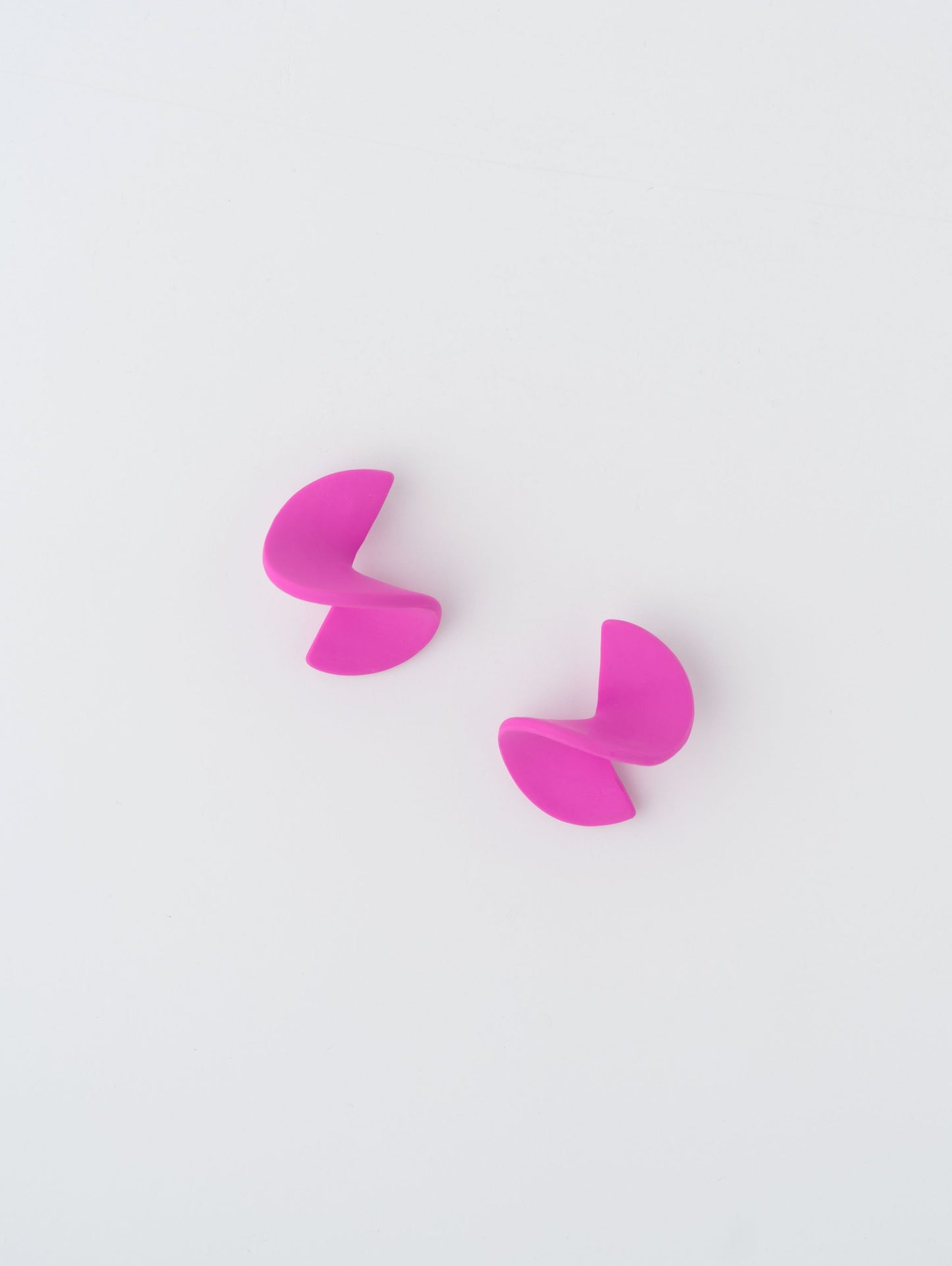 Swirl earrings by APÖ, handmade polymer clay earrings with a small unicolor spiral design, lightweight, minimalist, and artistic.