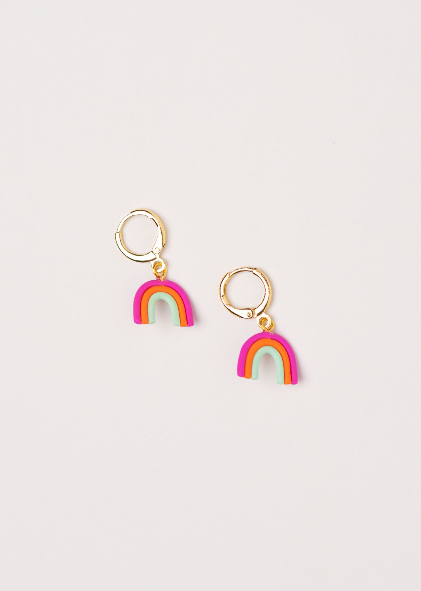 Little Rainbow earrings by Little APÖ, handmade polymer clay earrings in a small rainbow shape with three bright colors, playful, lightweight, and perfect for young girls.