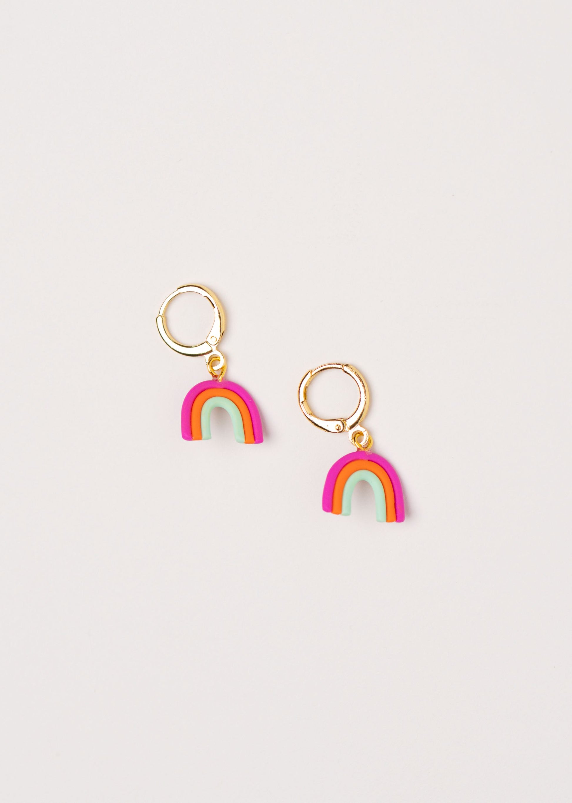 Little Rainbow earrings by Little APÖ, handmade polymer clay earrings in a small rainbow shape with three bright colors, playful, lightweight, and perfect for young girls.