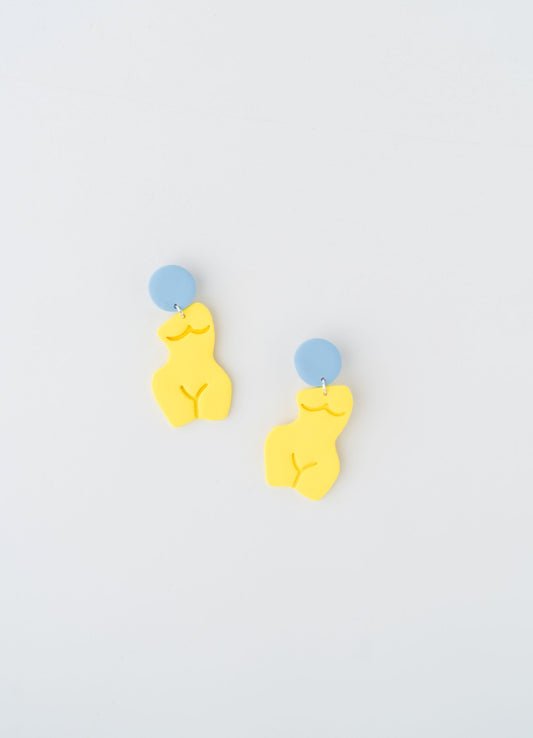 Silhouette earrings by APÖ, handmade polymer clay earrings shaped as a curvy feminine figure with a contrasting circular accent, medium-sized, artistic, and lightweight.