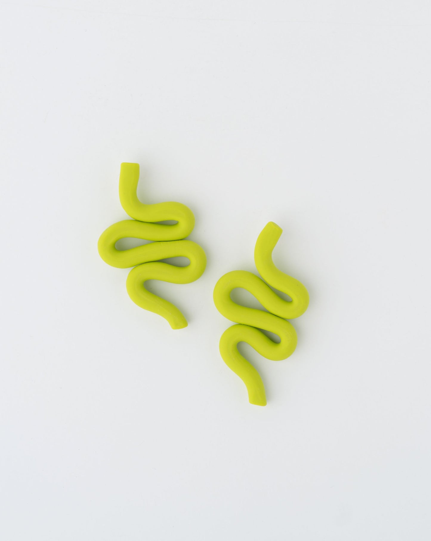 Handmade Snake earrings by APÖ, medium-sized polymer clay design with smooth curves inspired by serpents, lightweight and customizable.