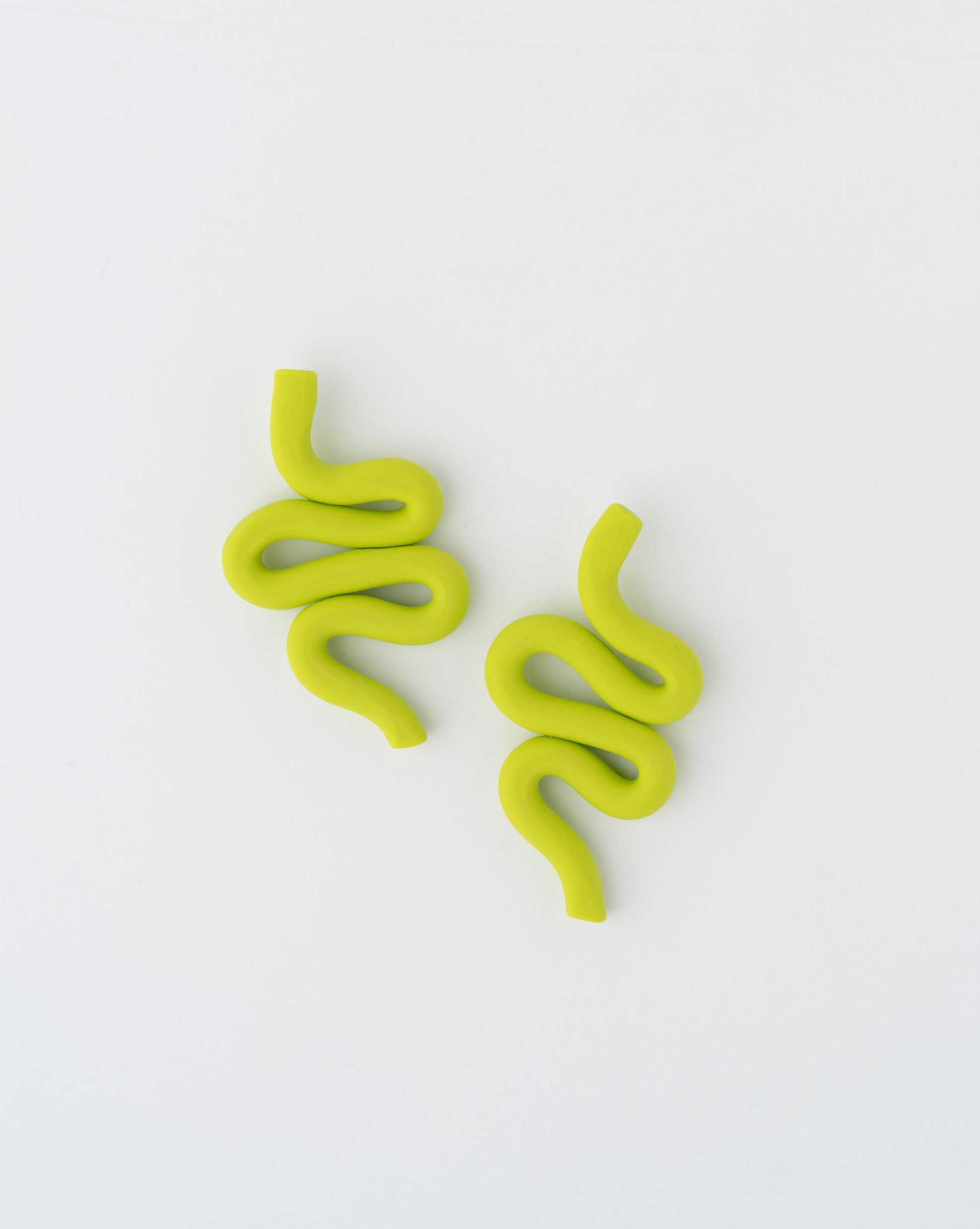 Handmade Snake earrings by APÖ, medium-sized polymer clay design with smooth curves inspired by serpents, lightweight and customizable.