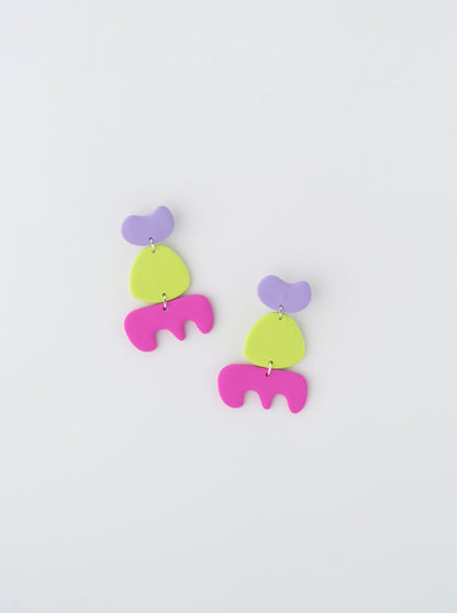 Walking earrings by APÖ, handmade polymer clay earrings featuring three abstract shapes in contrasting colors, medium-sized, lightweight, and expressive.