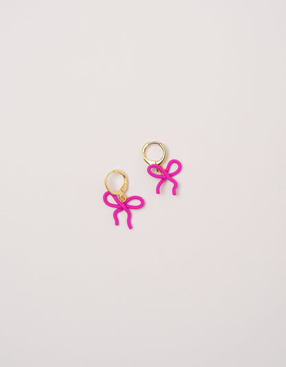 Wavy Bow earrings by Little APÖ, handmade polymer clay earrings in a small wavy ribbon shape, unicolor, lightweight, and designed for young girls.